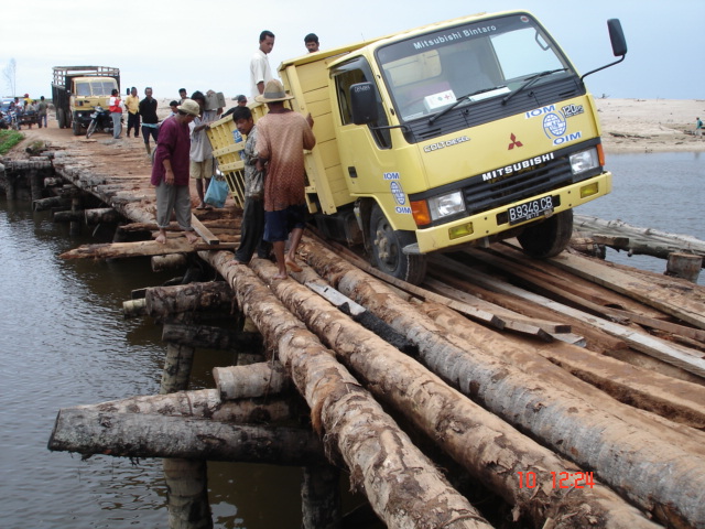 IOM truck on a log bridge in Indonesia